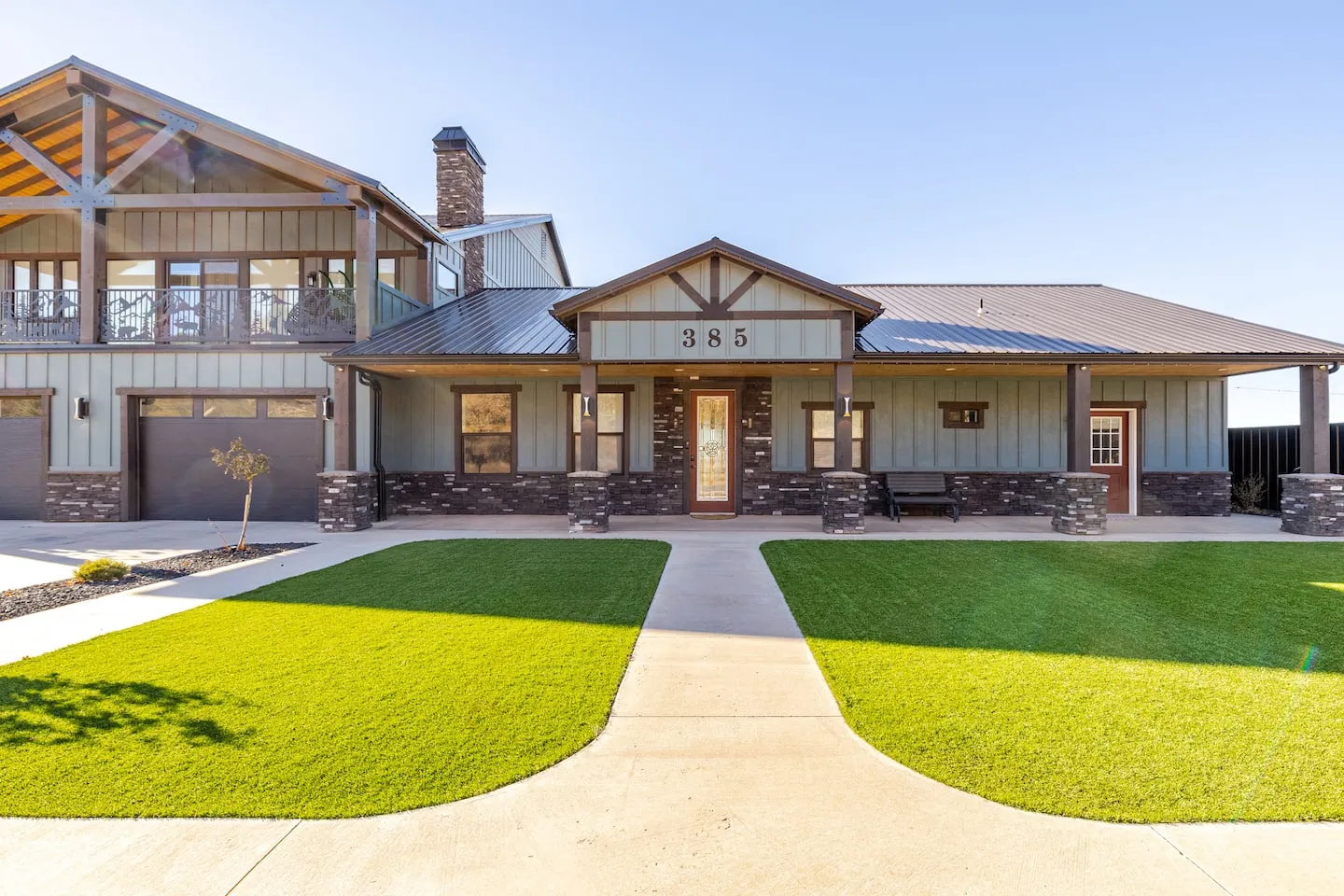 Front of Zion Vista: a two-story home with a covered porch and green lawn