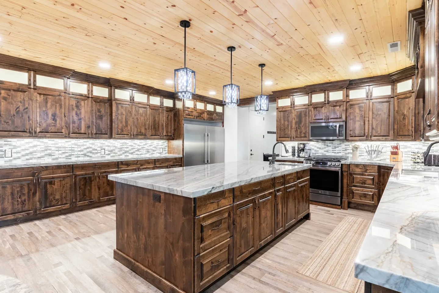 Kitchen with a large island, wood cabinets and pendant lights