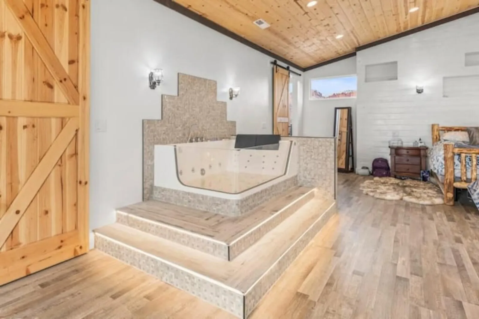 Raised soaker tub inside a bedroom suite