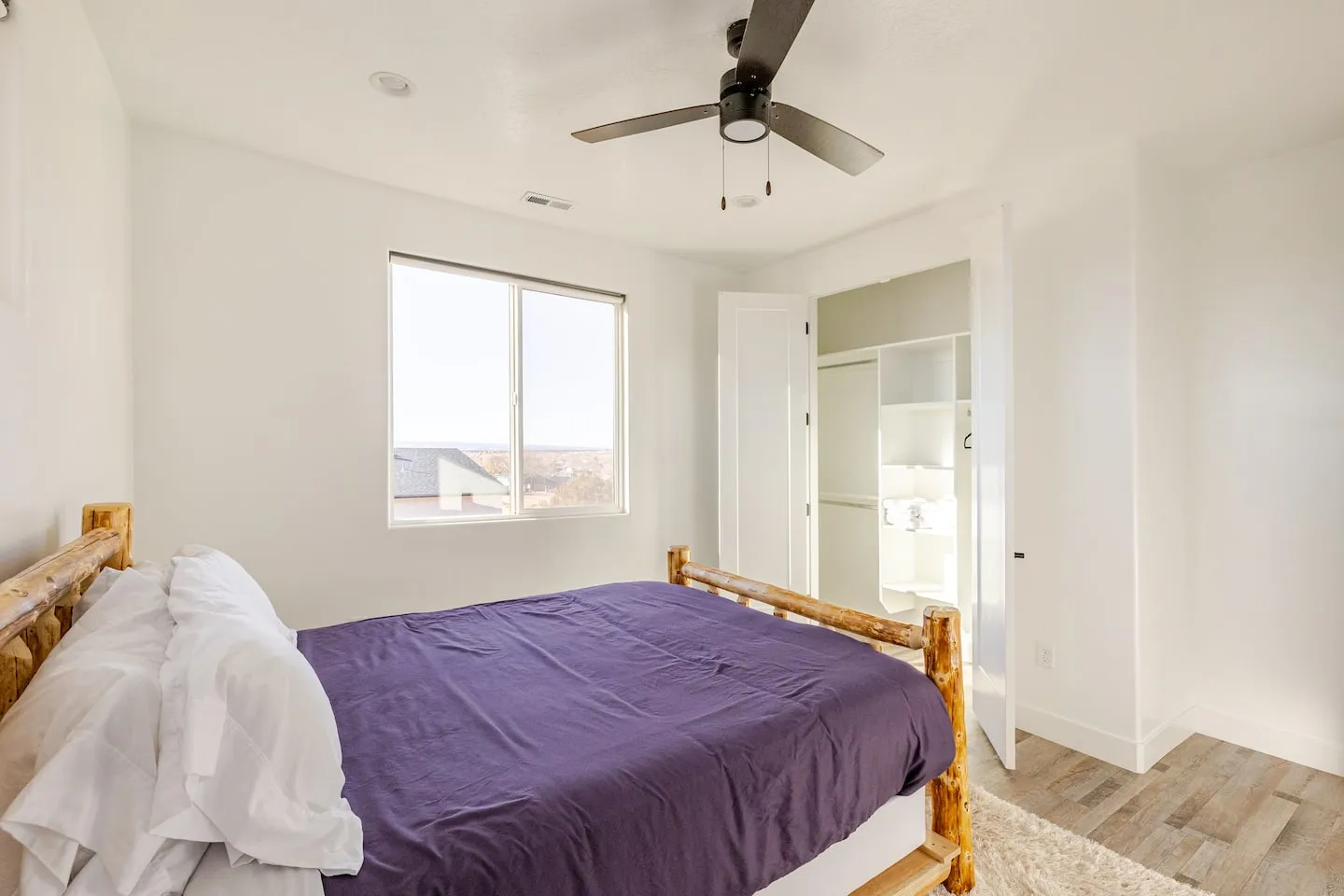 Bedroom with a log-frame bed and a large window